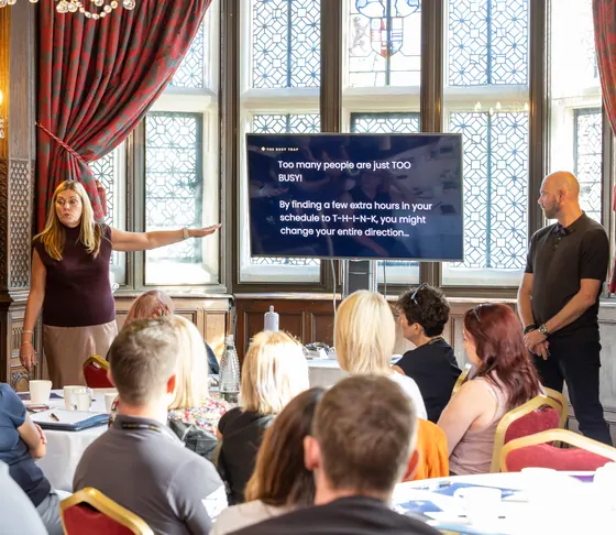 Jacquie Hale presenting to the room with David Butler alongside