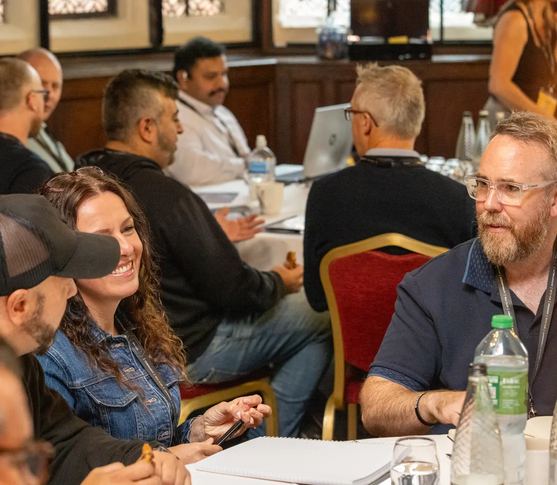 Business owners laughing around a table at a BGA Club day